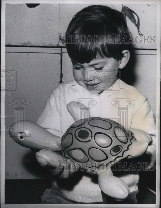 1960 Press Photo Paris, France young boy & inflatible rubber tortoise - Historic Images