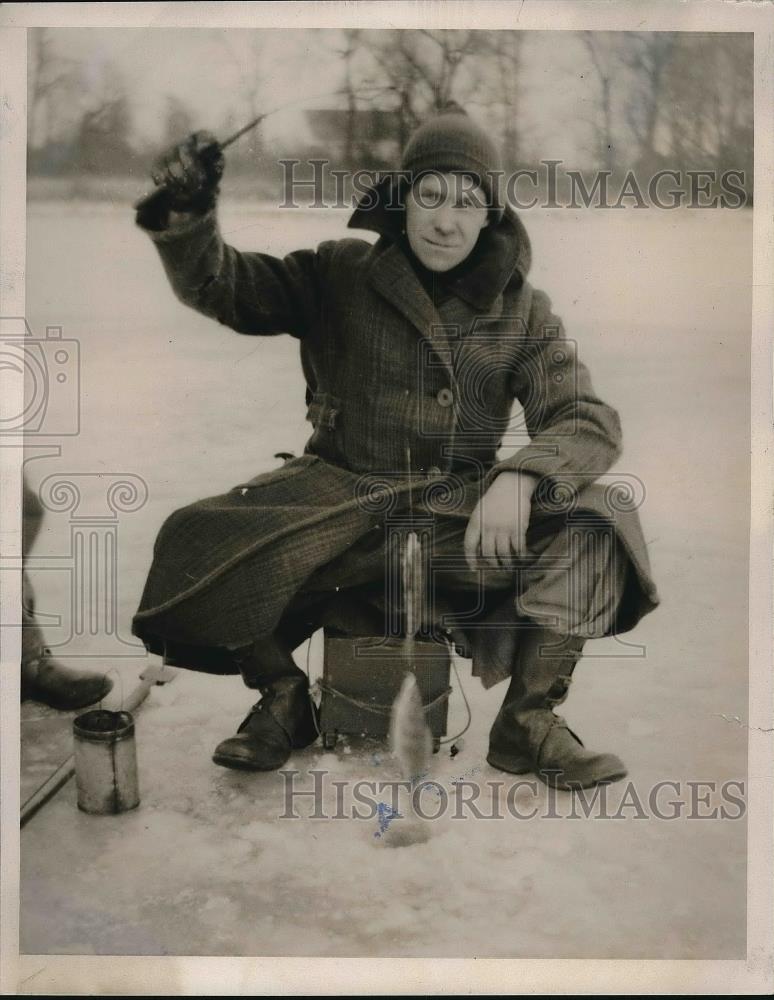 1940 Press Photo William Hummel displays two fish caught ice fishing - Historic Images
