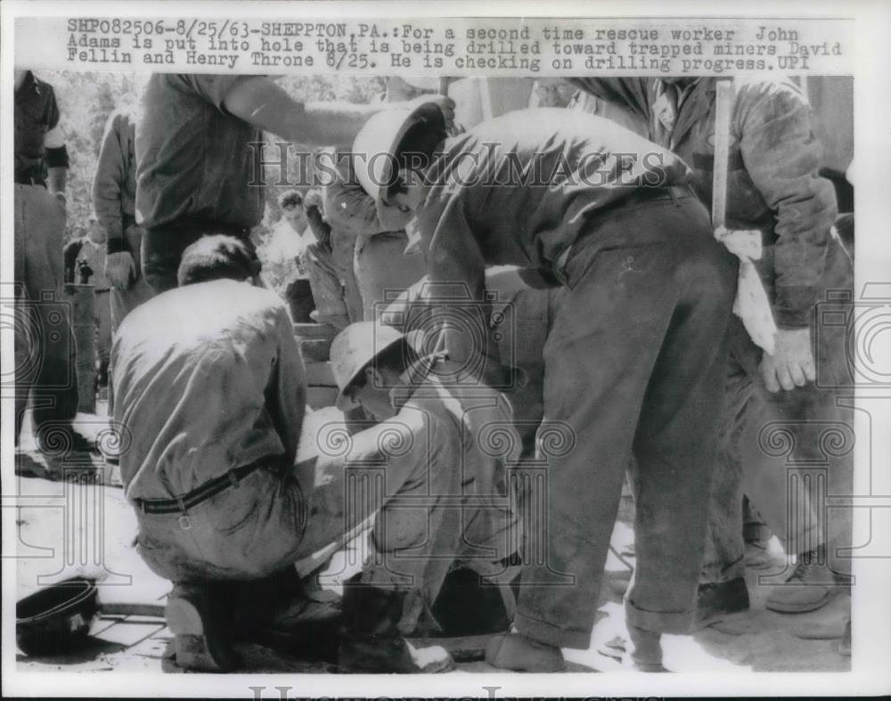 1963 Press Photo John Adams Put Into Hole That Is Being Drilled Toward Trapped - Historic Images