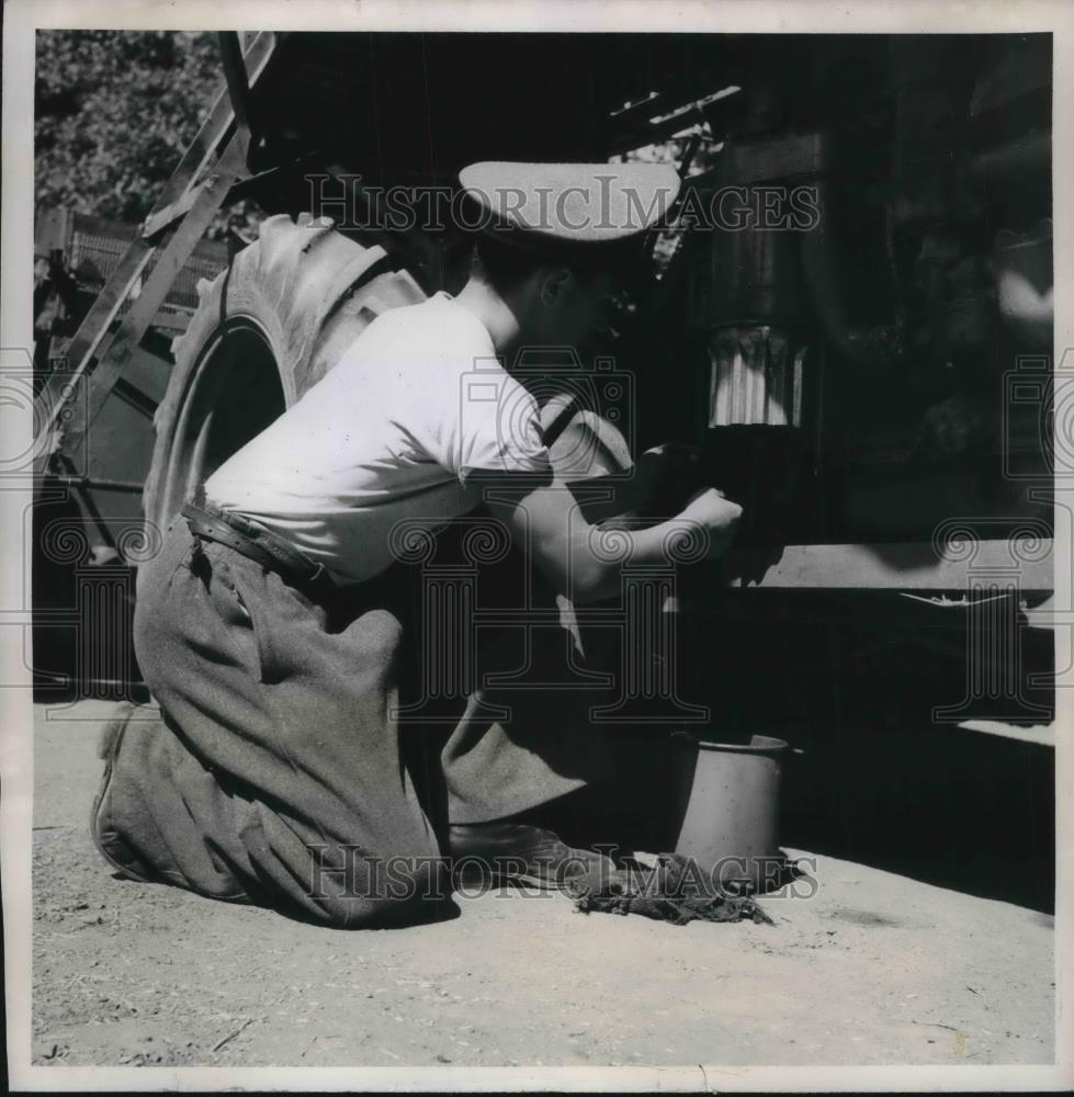 1951 Press Photo Farmhand learning to to use a maintaini U.S Farm machines. - Historic Images