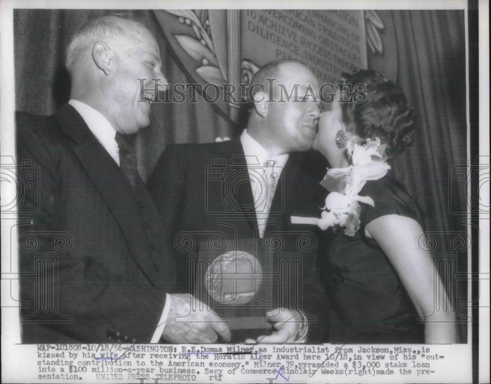 1956 Press Photo R. E. Dumas Milner, industrialist kissed byhis wife after - Historic Images