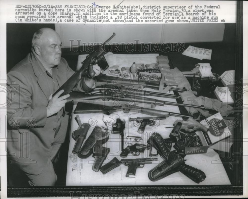 1957 Press Photo Col. George White posing with arsenal seized from Haig Terzian - Historic Images