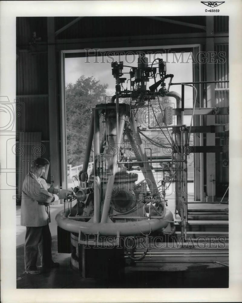 1957 Press Photo Technician Tests Rocket Engine at Lewis Rocket Research - Historic Images