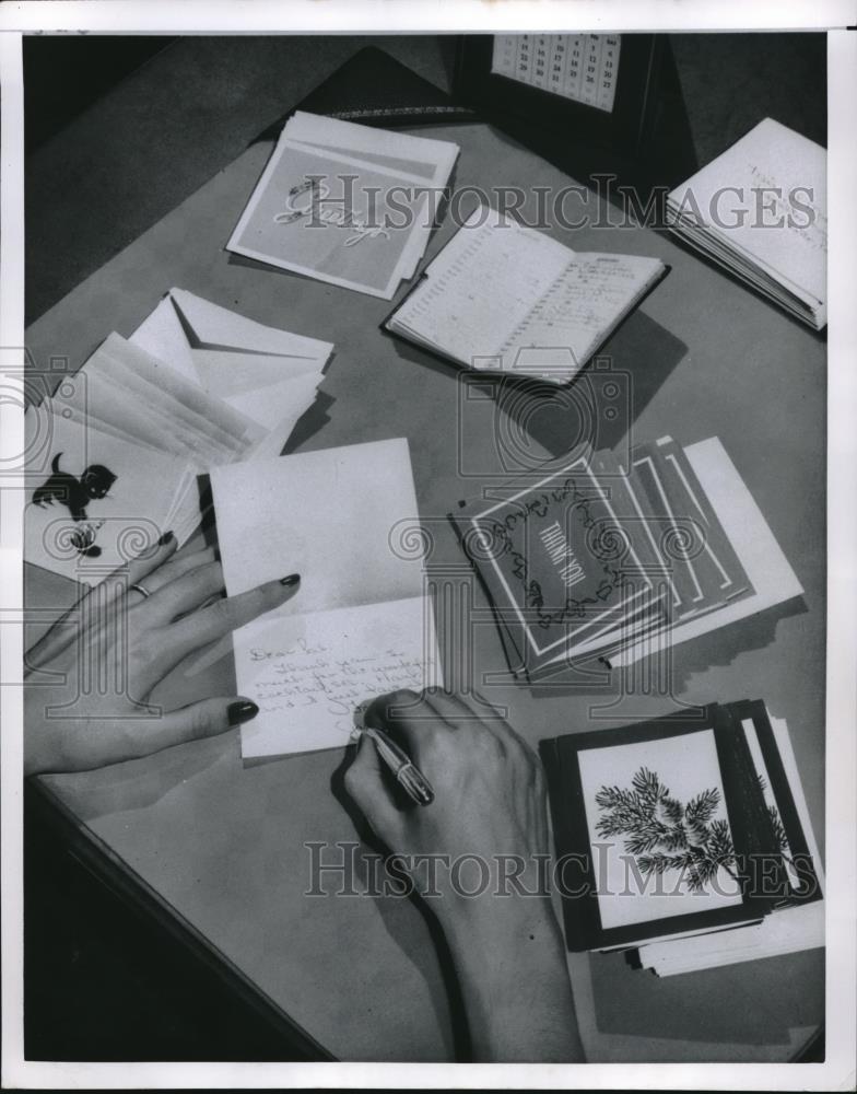 Press Photo A woman at her home office desk writing out cards - neb66108 - Historic Images