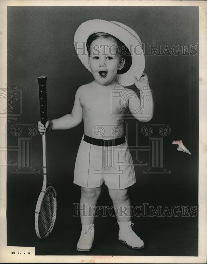 1960 Press Photo An unidentified child wearing a hat and holding racket - Historic Images