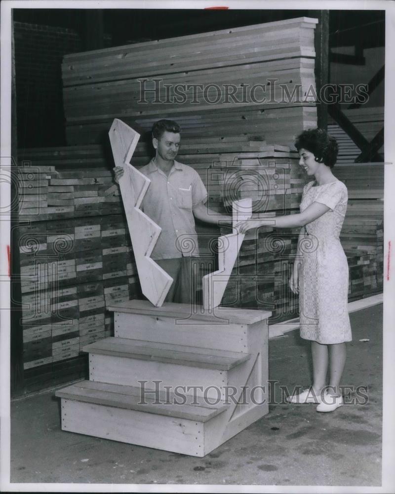 1962 Press Photo West End Lumber worker show a built it yourself Stairway Kit. - Historic Images