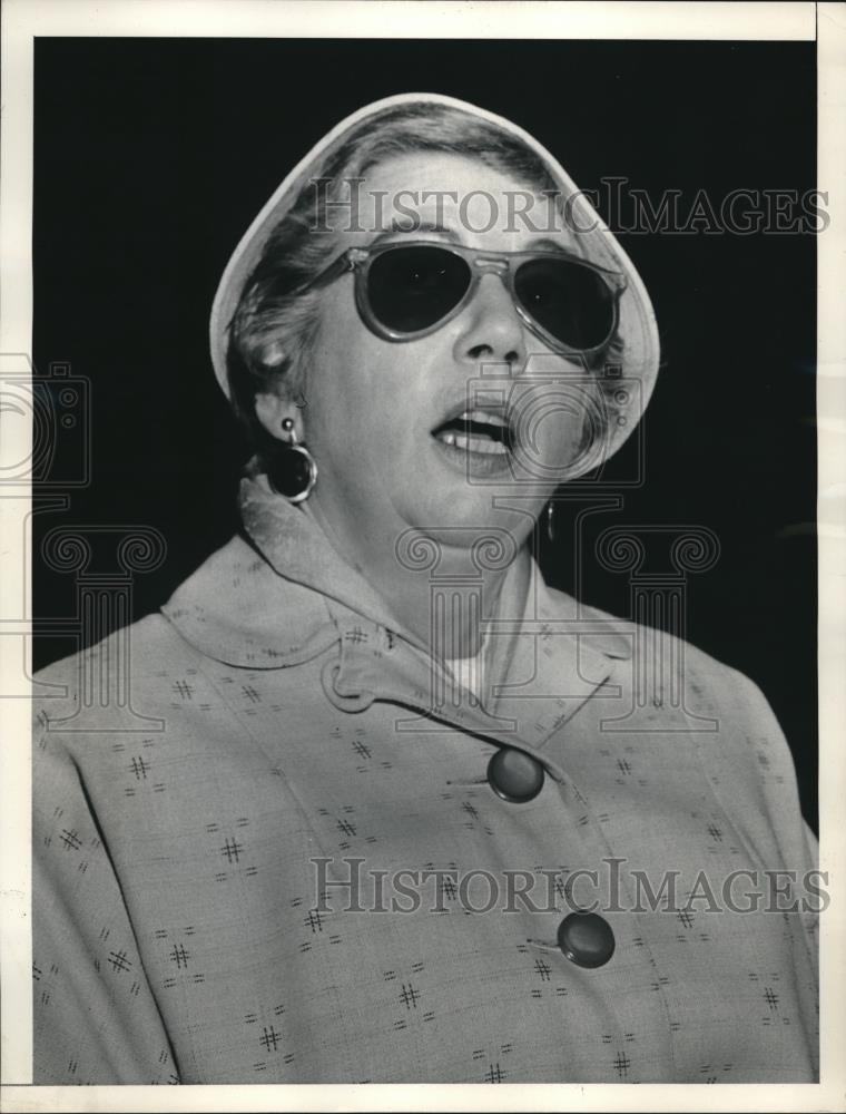 1956 Press Photo Elderly Lady In Chic Sunglasses And Coat Makes A Face - Historic Images