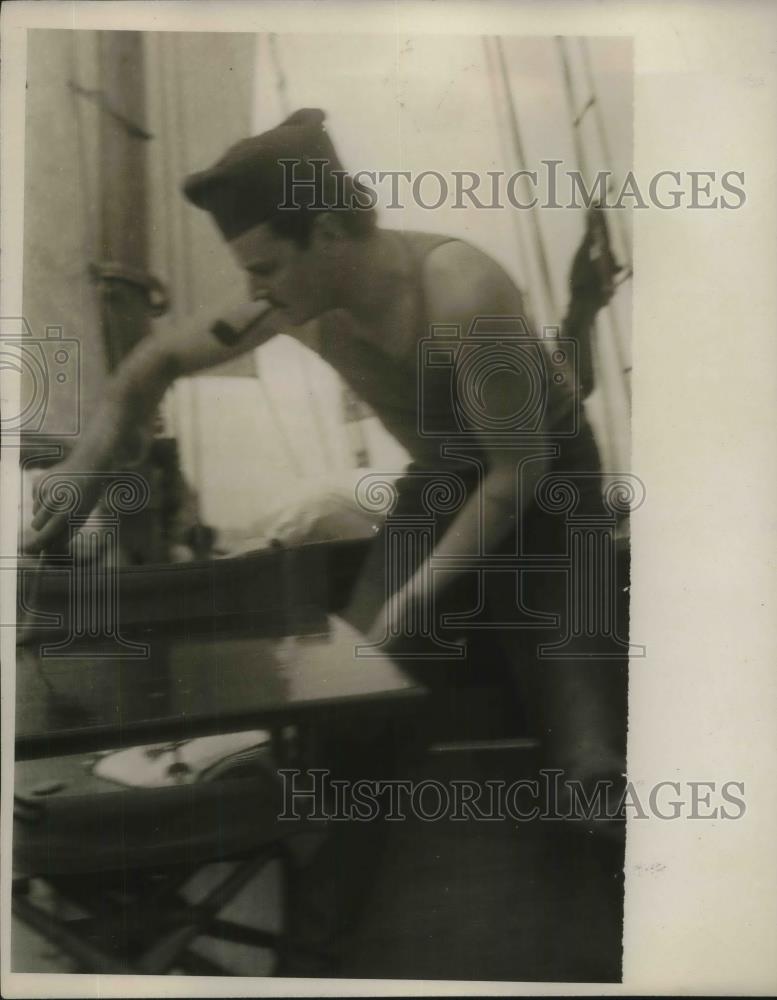 1928 Press Photo Skipper Ames varnishing a hatch Cover on boat - neb77064 - Historic Images