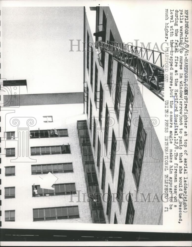 1961 Press Photo Firefighter Top Serial Ladder Yelling at Nurse - Historic Images