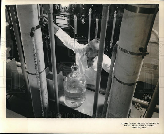 Press Photo Chemist Regulated Fuel at Aircraft Engine Research Laboratory - Historic Images