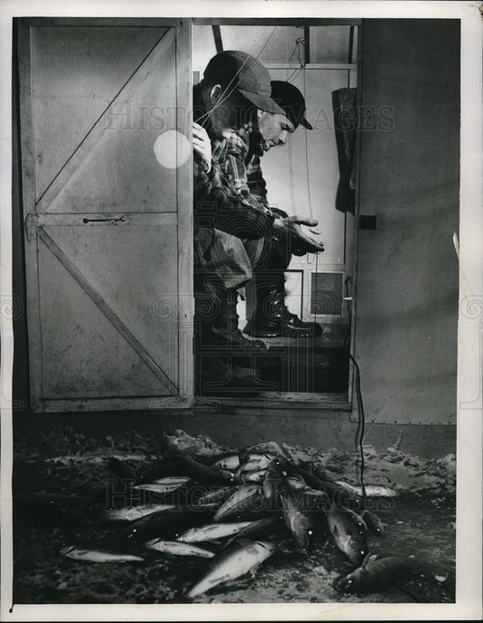 Press Photo Men Ice Fishing with Good Catch - Historic Images
