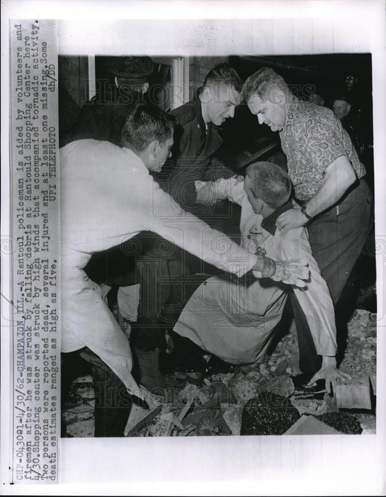 1962 Press Photo Bystanders Help Policeman Knocked Over By Debris - Historic Images