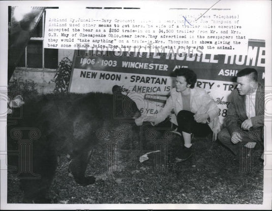 1955 Press Photo Mr & Mrs Joe Thompson accepting a bear as trade off to Tractor - Historic Images