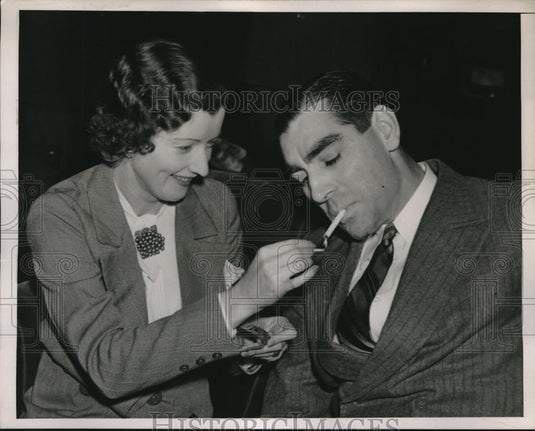 1939 Press Photo Mrs Patrick Chapman lighting the cigarette of her husband - Historic Images