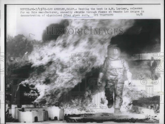 1961 Press Photo Salesman AM Larimer Demonstrates Aluminized Fiber Glass Suit - Historic Images