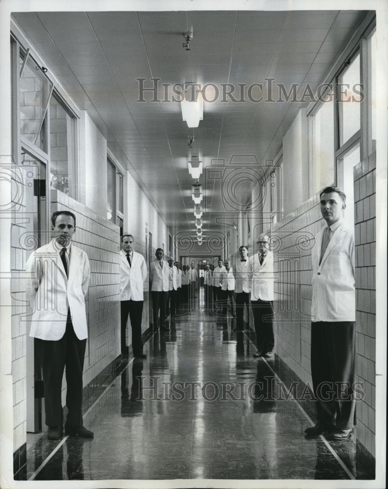 1961 Press Photo Scientist &amp; technicians line up at the main hall of Goodyear - Historic Images