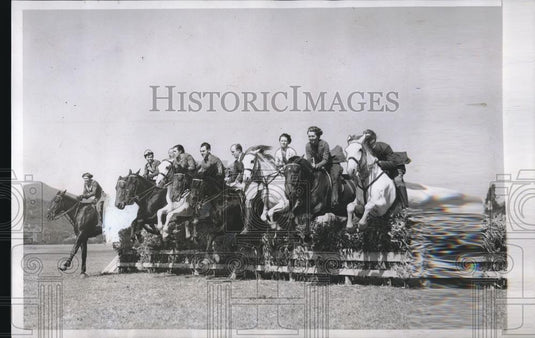 1934 Press Photo Ten Equestrians On Horses Jump Them Over A Fence At Same Time - Historic Images