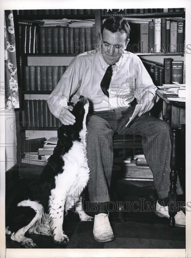 1946 Press Photo Chester Bowles receives consolation from his dog, Pete. - Historic Images