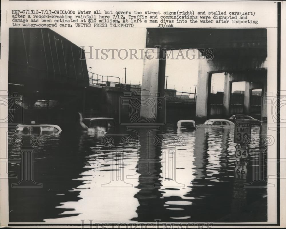 1957 Press Photo Man Dives Into Chicago Floodwaters To Inspect Car - nec34385 - Historic Images