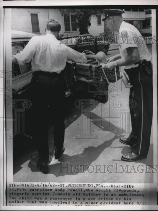 1962 Press Photo A baby being put inside the car. - Historic Images