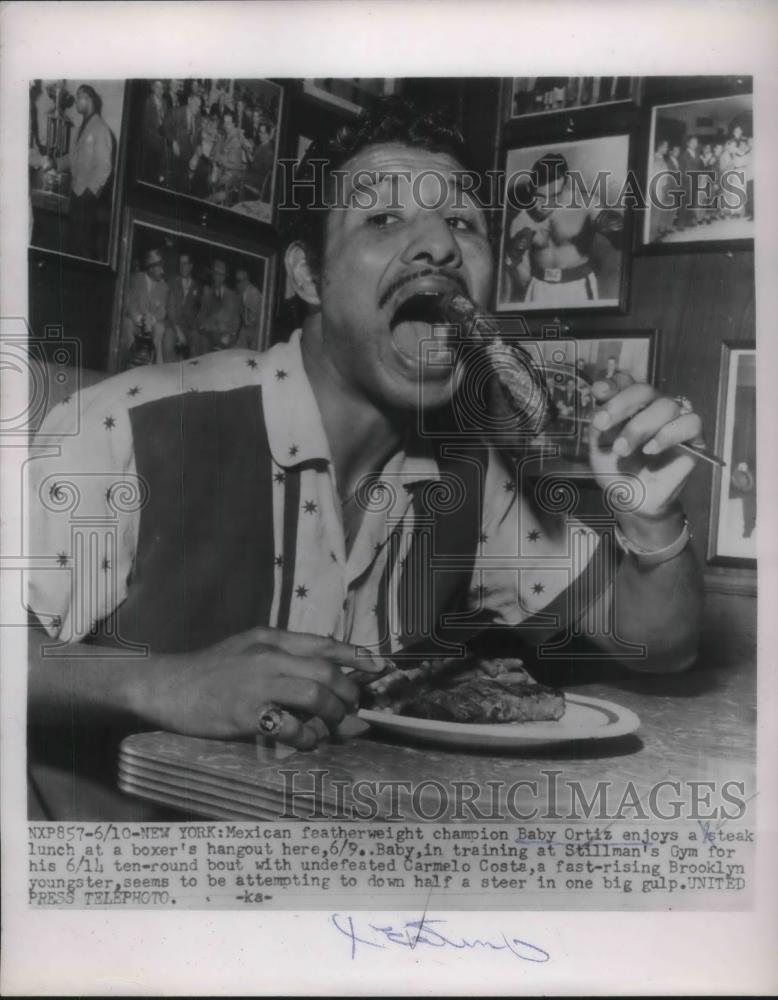 1954 Press Photo Mexican Featherweight baby Ortiz enjoyed a steak lunch. - Historic Images