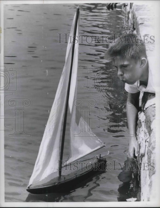 1961 Press Photo Jerry Micholski playing with his little boat. - Historic Images