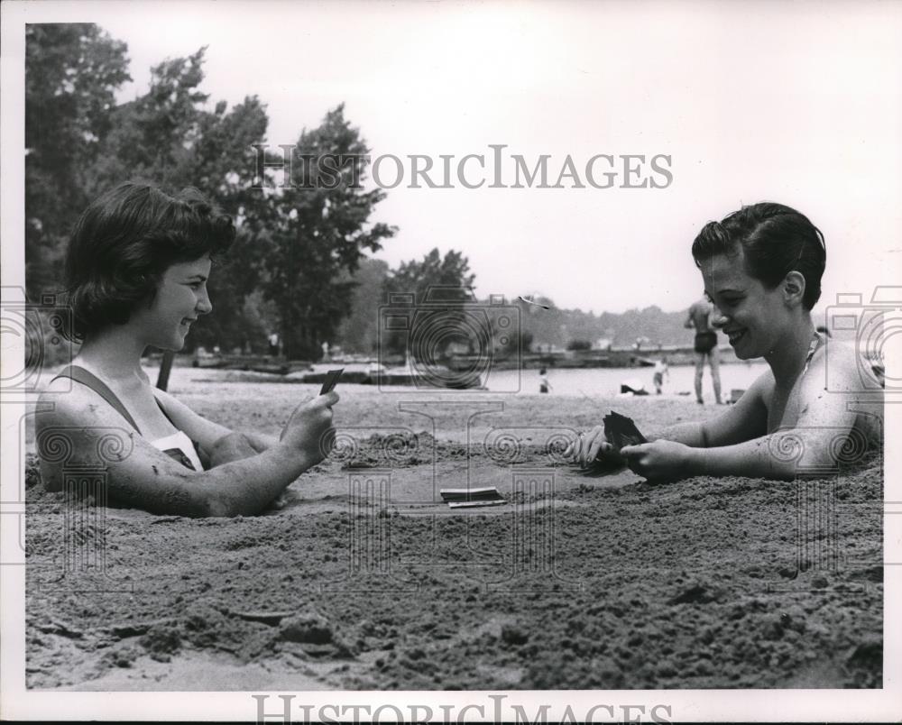 1956 Press Photo Karen Van ALlen and Carol Schultz buried in sand at HUntington - Historic Images