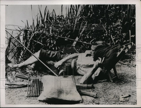 1937 Press Photo Man fishing on bank of a river in England - Historic Images