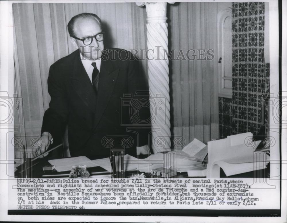 1935 Press Photo Guy Mollet prepared to return to Paris as police brace for riot - Historic Images