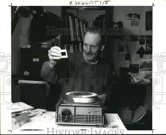 1990 Press Photo Michall Costello Sculptor shown with his Slide. - Historic Images
