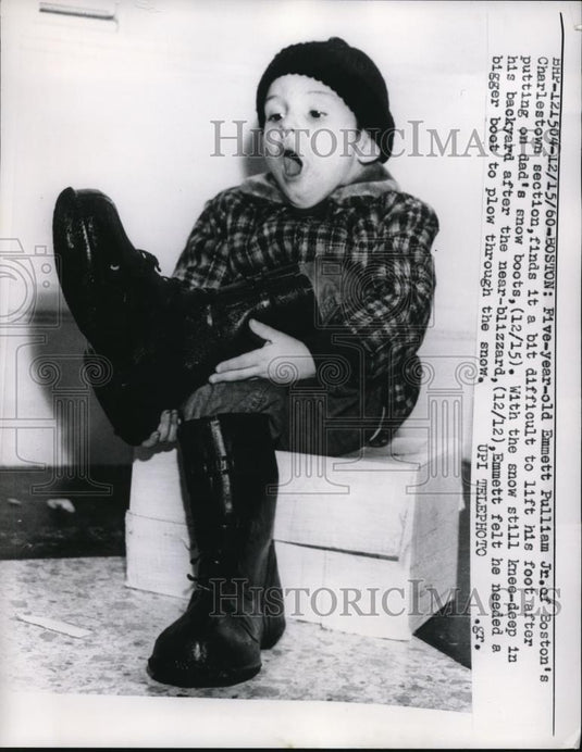 1960 Media Photo Emmett Pulliam Jr. putting on Dad's snow boots. - Historic Images