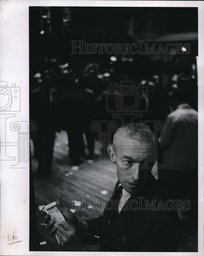 1966 Press Photo Man writing list on the streets - Historic Images