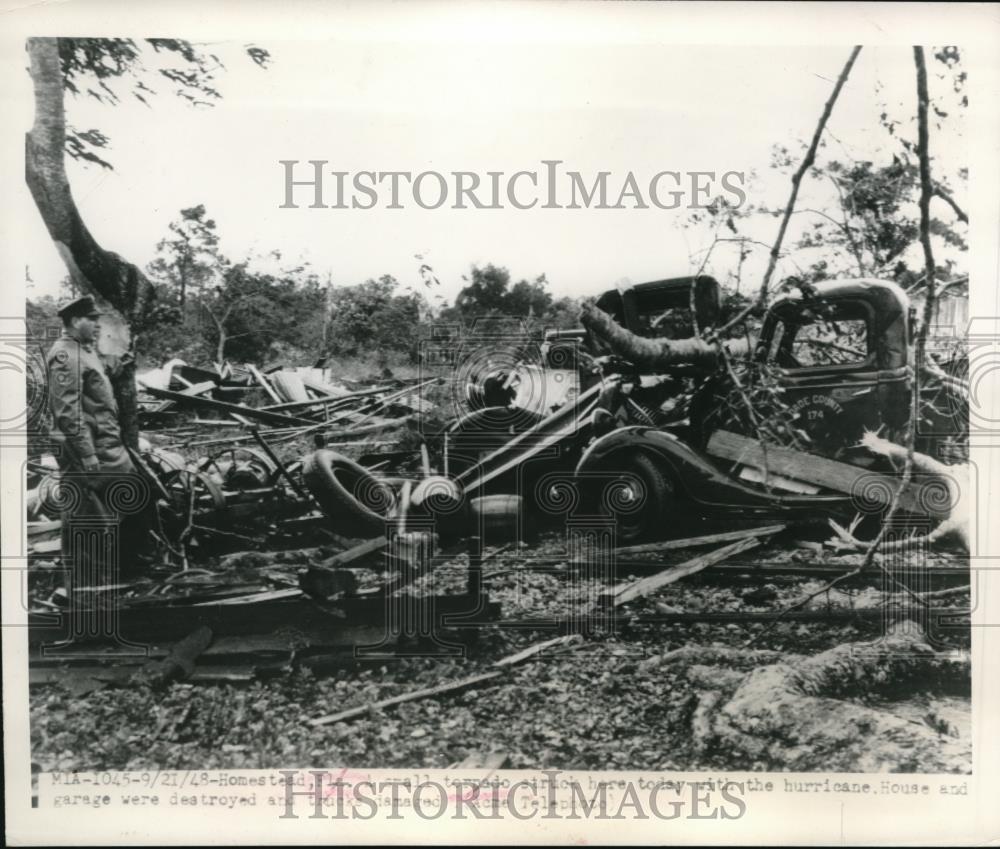 1948 Press Photo A small tornado strikes a small home and trucks in Miami, FLA - Historic Images