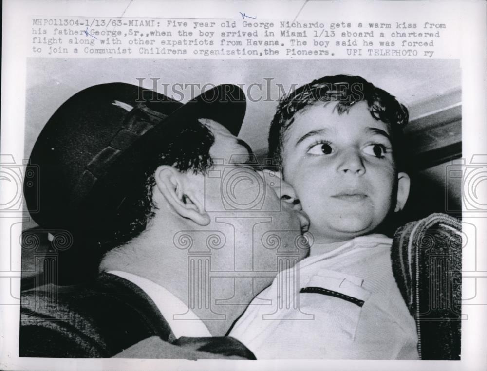 1963 Press Photo George Nichardo gets kiss from dad George Sr upon Miami arrival - Historic Images