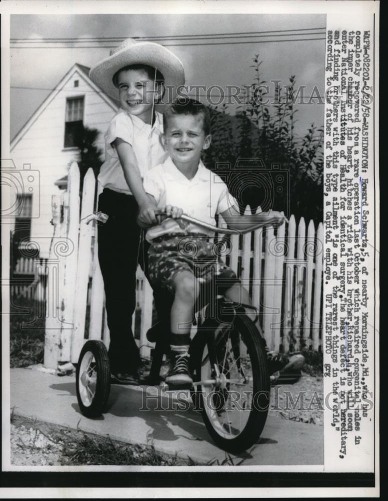 1958 Press Photo Brothers Howard and Richard Schwartz, riding a bike - Historic Images