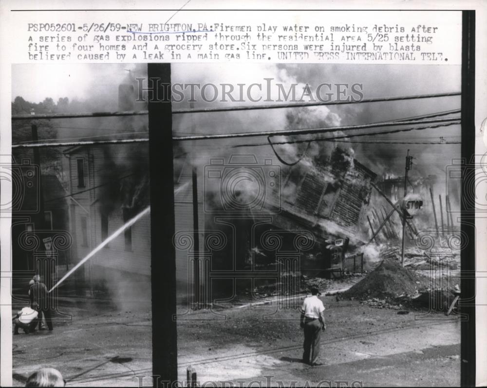 1959 Press Photo New Brighton Pa Firement play water on smoking debris after - Historic Images