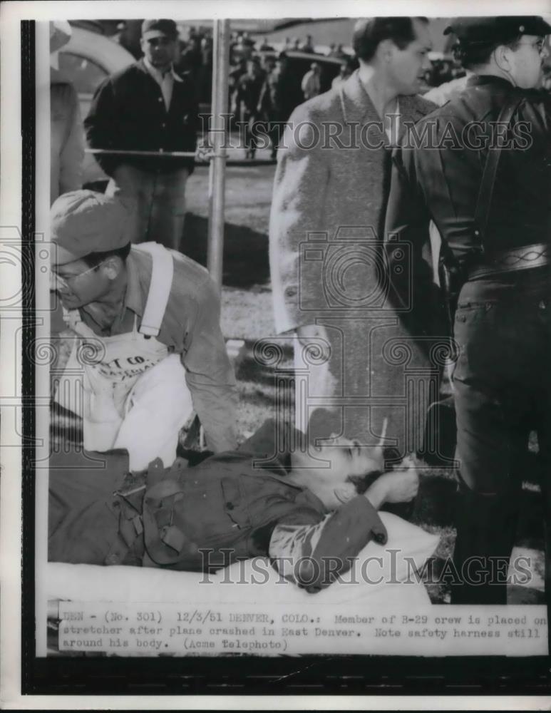 1951 Press Photo Member of B29 crew on stretcher after plane crashed in river - Historic Images