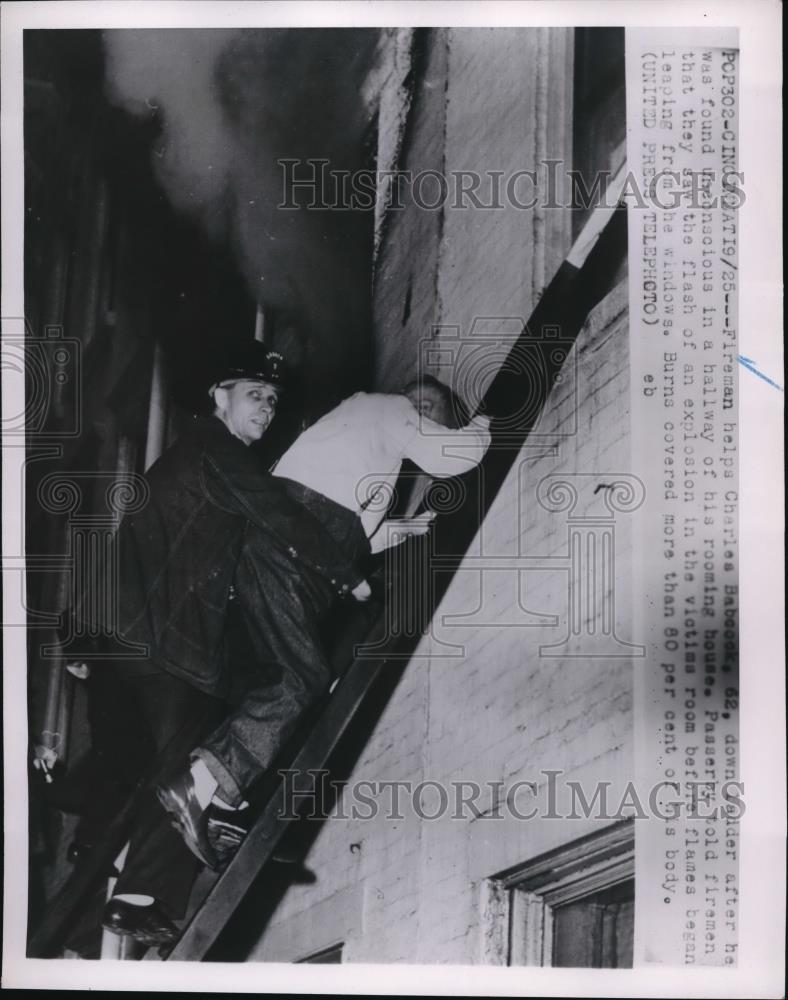 1952 Press Photo Fireman Helped 62-year-old Charles Babcook, Explosion Victim - Historic Images