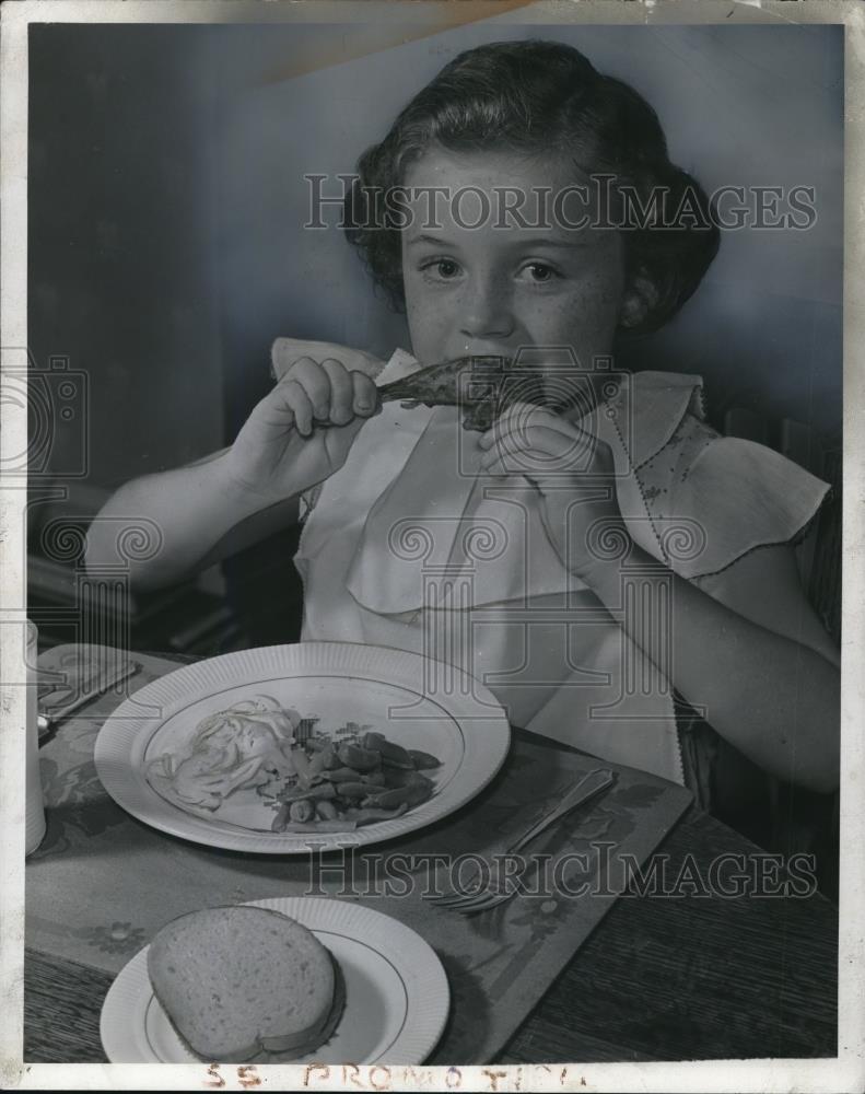 1943 Press Photo Carol Bingham, eating drumsticks worth waiting dinner - Historic Images