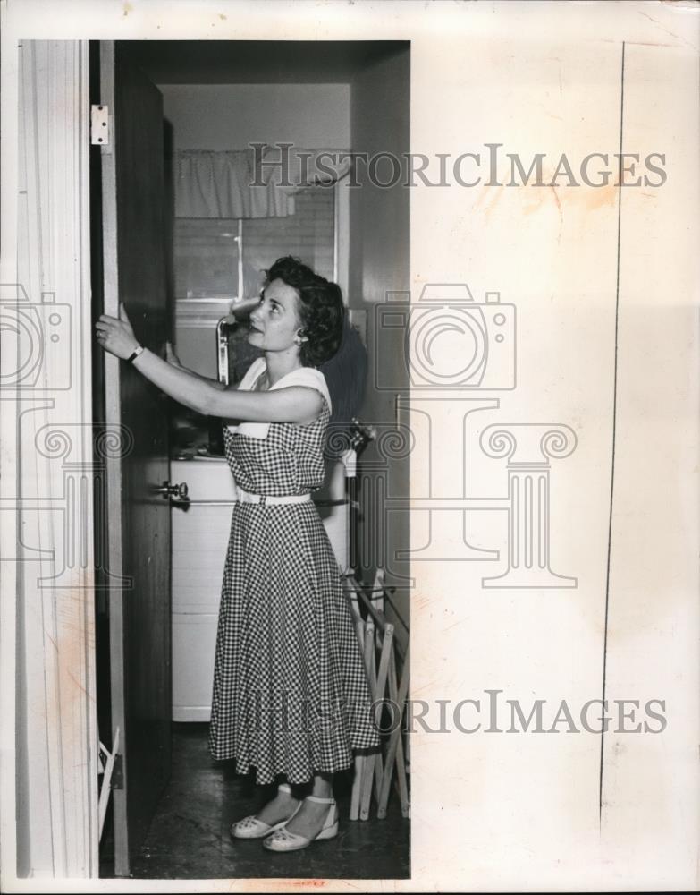 1958 Press Photo Mrs Amma Bonnino hangs door blown off hinge at home - Historic Images