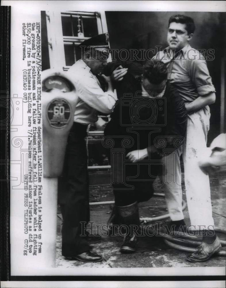 1956 Press Photo Fire dept Lt William Paulson helped by policeman after he fell - Historic Images