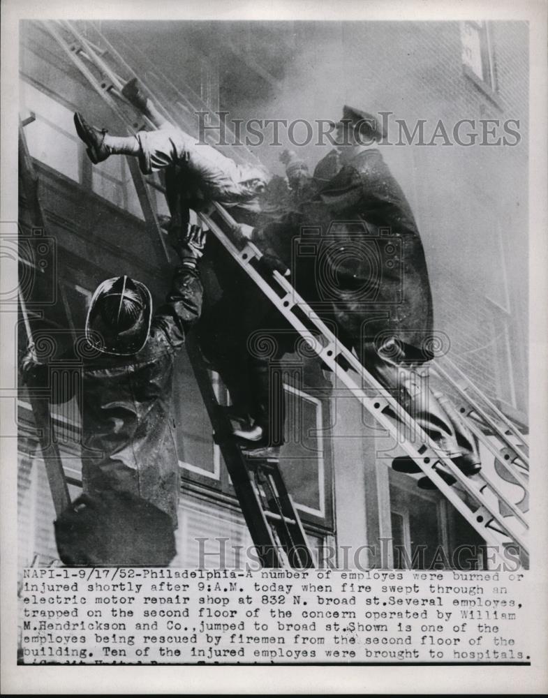 1952 Press Photo One of the employees being rescued by firemen - Historic Images