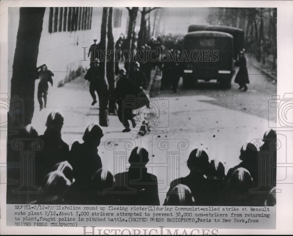 1952 Press Photo Police round up fleeing rioter during strike at Renault Plant - Historic Images