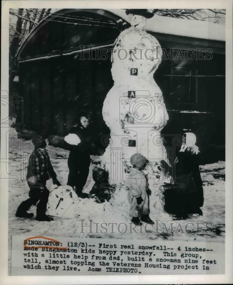 Children build a tall snowman in Binghamton NY Veterans housing - Historic Images