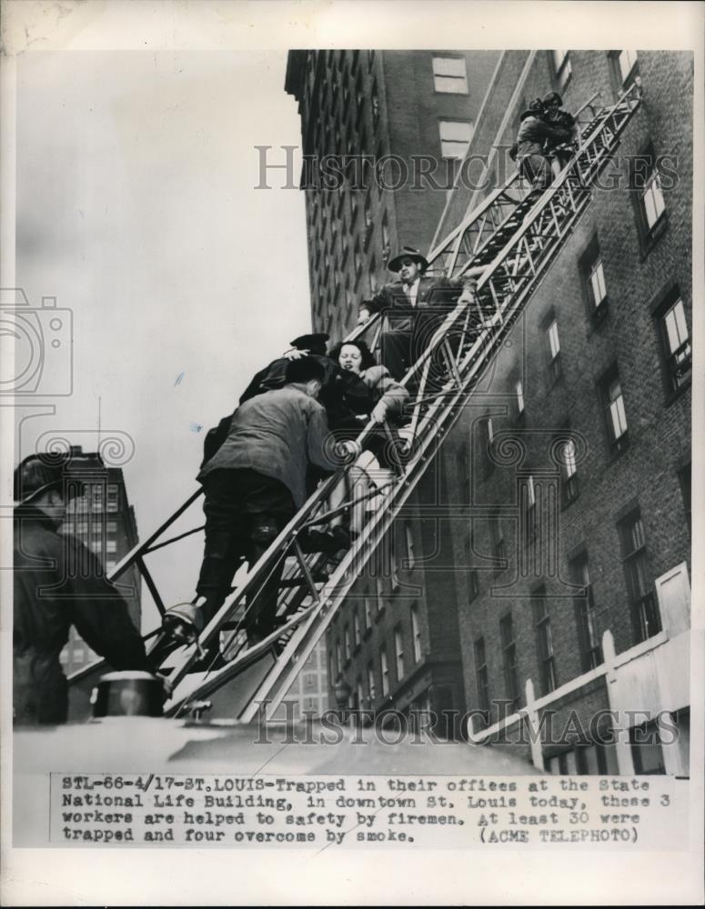 1950 Press Photo Workers of the State National Building being helped to safety - Historic Images