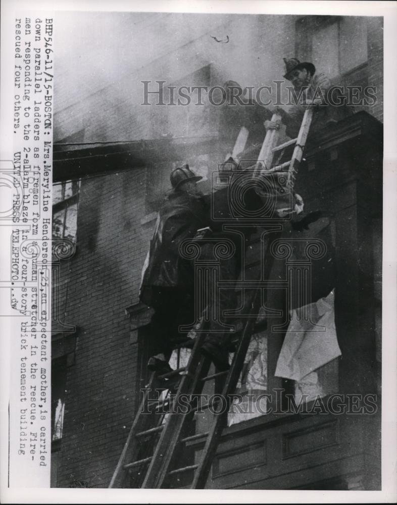 1954 Press Photo Mrs. Meryline Henderson carried down by firemen during the fire - Historic Images