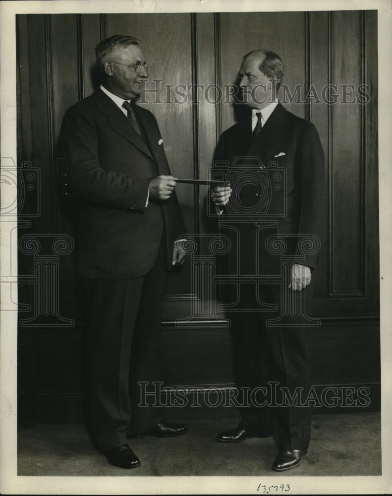 1930 Press Photo Edward C Seubert President of Standard Oil Company handing a - Historic Images