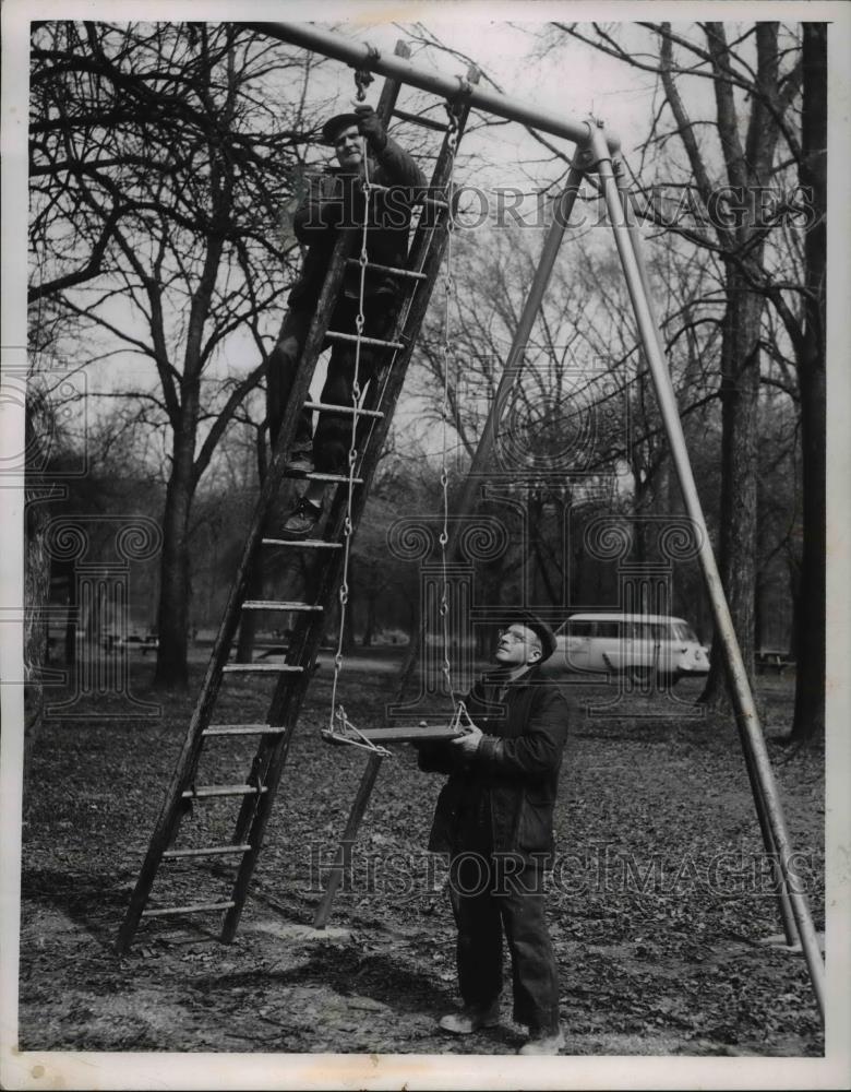 1956 Press Photo Oscar Oragel and William Boettler repairing a swing - Historic Images