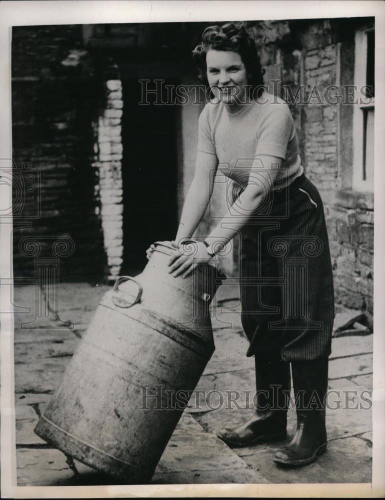 1940 Press Photo Peggy Barden with milk cans at farm in Shepley England - Historic Images