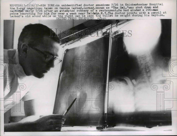 doctor examines the X-ray negatives taken on George Larned 1957 Vintage ...